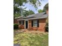 Traditional brick house with a dark front door and black shutters, set on a green lawn at 4712 Rockstile Way, Stone Mountain, GA 30083
