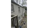 Home exterior showcasing the siding, windows, and a partial view of the yard and surrounding area at 4064 Sunset Sw Dr, Atlanta, GA 30331