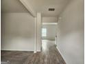 Neutral-toned hallway showcasing the transition between carpeted and wood-look flooring at 883 Ironhorse Sw Ln, Mableton, GA 30126