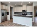 Modern kitchen featuring stainless steel appliances, gray countertops, and stylish backsplash at 883 Ironhorse Sw Ln, Mableton, GA 30126