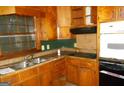 Functional kitchen with wood cabinets, stainless steel sink, and modern appliances at 3296 Columbia Woods Dr, Decatur, GA 30032