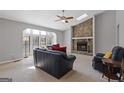 Cozy living room featuring a stone fireplace and ample natural light from large windows at 4811 Nevilly Way, Marietta, GA 30066