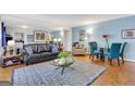 Open floor plan with a large mirror wall, hardwood floors and a black leather sofa at 300 Peachtree Ne Ave # 22N, Atlanta, GA 30305