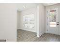 Living room with grey wood flooring, neutral paint, and ample natural light at 474 Cantrell Drive, Dallas, GA 30157