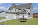 Charming two-story home featuring a two-car garage and a well-manicured lawn at 412 Cantrell Drive, Dallas, GA 30157