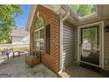 Inviting front entrance showcasing a brick facade, large window, and a covered entryway for guests at 5045 Edinborough Pl, Sugar Hill, GA 30518