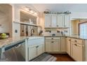 Well-lit kitchen featuring granite countertops, a farmhouse sink, and custom cabinetry for ample storage space at 5045 Edinborough Pl, Sugar Hill, GA 30518