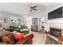 Spacious living area featuring vaulted ceilings, fireplace, and an open doorway to the bedroom at 75 Mcintosh Estates Dr, Sharpsburg, GA 30277