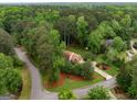 Aerial view of a home nestled among lush trees, showcasing its private and serene setting at 100 Hartford Pl, Fayetteville, GA 30214