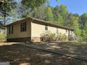 Single story home featuring a low-pitched roof, horizontal siding, and an extended concrete walkway at 30 Woodfield Rd, Covington, GA 30014