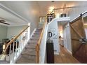 Open foyer featuring a staircase with white railing, barn door accent, and hardwood floors at 80 Jacksons Vly, Sharpsburg, GA 30277