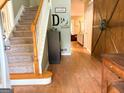 Inviting foyer with hardwood floors, carpeted stairs, and a decorative barn door at 80 Jacksons Vly, Sharpsburg, GA 30277