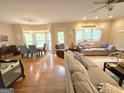 Open-concept living room and dining area, showcasing hardwood floors and natural light at 80 Jacksons Vly, Sharpsburg, GA 30277