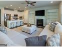 Bright, open-concept living room with fireplace, built-ins, and a view of the modern kitchen at 360 Hayden Cir, Woodstock, GA 30189
