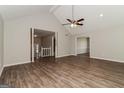Spacious living room with wood floors, high ceilings, and an open layout to the staircase and dining room at 8091 Bouldercrest Pl, Douglasville, GA 30135