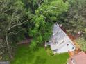 An aerial view of a home surrounded by lush trees and green lawns at 3979 Doral Cir, Atlanta, GA 30360