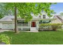 Charming home with a welcoming front porch, a vibrant red door, and well-manicured lawn at 3979 Doral Cir, Atlanta, GA 30360