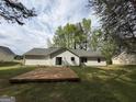 A large backyard with a wood deck, perfect for outdoor entertaining or relaxing at 130 Elm St, Hampton, GA 30228