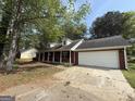 A view of the front of the house showing the brick exterior, two dormer windows, and the garage at 130 Elm St, Hampton, GA 30228