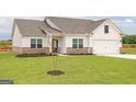 Beautifully landscaped single-Gathering home with a well-manicured lawn at 255 Oliver Dr, Locust Grove, GA 30248