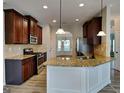 Charming kitchen with stainless steel appliances, island, and granite countertops at 305 Mango Ct, Mcdonough, GA 30253