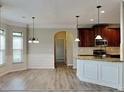 Bright kitchen with pendant lighting overlooking the breakfast nook, promoting open floorplan at 305 Mango Ct, Mcdonough, GA 30253