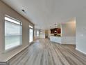 Spacious open-concept living area featuring lots of natural light and hardwood style floors at 305 Mango Ct, Mcdonough, GA 30253