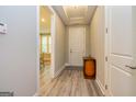 Inviting entryway features hardwood floors, neutral walls, and a view of the dining room beyond at 444 Silverbell Ct, Peachtree City, GA 30269