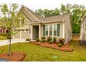 Attractive home showcasing a manicured lawn, mature trees, and a convenient two-car garage at 444 Silverbell Ct, Peachtree City, GA 30269