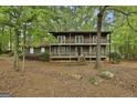 Charming two-story home featuring a double balcony and lush, mature landscaping at 101 Longer Dr, Peachtree City, GA 30269