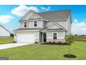 Beautiful home with a well-maintained lawn and attractive landscaping at 235 Oliver Dr, Locust Grove, GA 30248