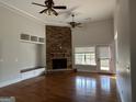Bright living room features a stone fireplace, built-in shelving, hardwood floors and abundant natural light at 6504 Cedar Mountain Rd, Douglasville, GA 30134