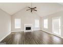 Bright living room featuring a fireplace, wood floors, and natural light at 121 Crestwood Ct, Hampton, GA 30228