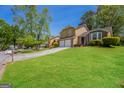 Charming two-story home with a two-car garage and a lush green lawn at 3913 Landgraf Cv, Decatur, GA 30034