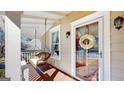 Relaxing front porch with a hanging swing, decorative front door and stained wood flooring at 2897 Macaw Nw St, Atlanta, GA 30318