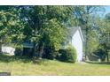 Inviting home nestled amongst mature trees; features a backyard deck at 6012 Happy Trls Ct, Lithonia, GA 30058