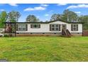 Attractive single-story home with dark trim, green grass, and a covered front porch at 80 David Rd, Hampton, GA 30228