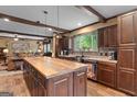 Spacious kitchen with wooden cabinets, an island, and stainless steel appliances at 80 David Rd, Hampton, GA 30228