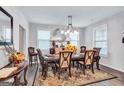 Elegant dining room featuring a large table with seating for six and decorative accents at 3259 Baylor Cir, Mcdonough, GA 30253
