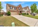 Traditional two-story home featuring a brick facade, well-kept lawn, and long driveway at 3259 Baylor Cir, Mcdonough, GA 30253