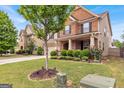 Lovely home with manicured landscaping, a well-maintained lawn, and brick accents at 3259 Baylor Cir, Mcdonough, GA 30253