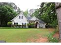 Beautiful home exterior with manicured lawn, mature trees, and decorative shrubbery at 416 Line Creek Cir, Sharpsburg, GA 30277