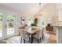 Bright dining room with vaulted ceilings, modern lighting, and access to the backyard at 405 Sherrels Frd, Peachtree City, GA 30269