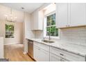 Modern kitchen with white cabinetry, stainless steel appliances, granite countertops, and a bright, airy feel at 405 Sherrels Frd, Peachtree City, GA 30269