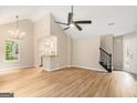 Open-concept living room with vaulted ceiling, hardwood floors, and seamless kitchen access at 405 Sherrels Frd, Peachtree City, GA 30269