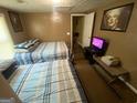Cozy bedroom featuring two beds with striped bedding and a television at 5172 Avery Sw St, Covington, GA 30014