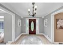 Inviting foyer with a beautiful wooden front door, chandelier, and decorative accents throughout at 5045 Rock Springs Rd, Lithonia, GA 30038