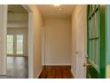 Inviting foyer with hardwood floors and a view into a living area with a patio door at 7017 Sun Valley Way, Riverdale, GA 30274