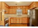 Traditional kitchen with wooden cabinets, stainless steel appliances, and laminate countertops at 7017 Sun Valley Way, Riverdale, GA 30274
