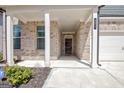 Welcoming entryway with brick walls and a covered porch, leading to the main entrance of the home at 221 Caledonia Ct, Peachtree City, GA 30269